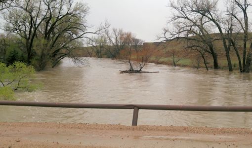 1,260 cfs at Smoky Hill River near Schoenchen, KS on Apr. 17, 2016. Photo by Andrew Clark, USGS.