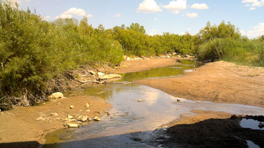0.87 cfs at Arkansas River near Syracuse, KS on July 17, 2012. Photo by Travis See, USGS.